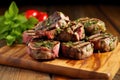 grilled lamb chops stacked on a wooden chopping board Royalty Free Stock Photo
