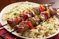 grilled lamb kebabs nestled on beds of couscous