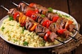 grilled lamb kebabs nestled on beds of couscous