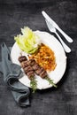 Grilled lamb kebabs on rosemary skewers, fried parsnips and Iceberg lettuce