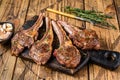 Grilled lamb mutton meat chops steaks on a cutting board. wooden background. Top view