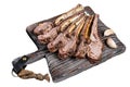 Grilled Lamb mutton Ribs Chops steaks on wooden board. Isolated on white background, top view. Royalty Free Stock Photo