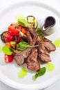 Grilled Lamb Rack with Baked Vegetables on White Restaurant Plate Top View Royalty Free Stock Photo