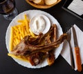 Grilled lamb rib chop steaks, medium rare with french fries on plate Royalty Free Stock Photo