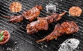 Grilled lamb ribs meat or rib eye with tomato sauce over the coals on a barbecue, dark background. Top view Royalty Free Stock Photo