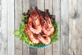 Grilled large fresh prawns served with megetables on blue plate