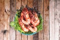 Grilled large fresh prawns served with megetables on blue plate