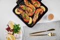 Grilled large queen shrimps with lemon and spices on the grill pan