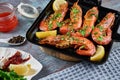 Grilled large queen shrimps with lemon and spices on the grill pan