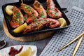 Grilled large queen shrimps with lemon and spices on the grill pan