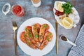 Grilled large queen shrimps with lemon and spices on the plate