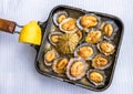 Grilled limpets in the pan served with lemon Royalty Free Stock Photo