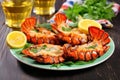 grilled lobster tails on a ceramic plate with greens Royalty Free Stock Photo