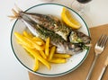 Grilled mackerel fish with french fries and lemon Royalty Free Stock Photo