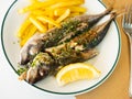 Grilled mackerel fish with french fries and lemon Royalty Free Stock Photo