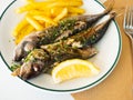 Grilled mackerel fish with french fries and lemon Royalty Free Stock Photo