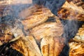 Grilled mackerel fish with smoke on a charcoal barbecue grill Royalty Free Stock Photo