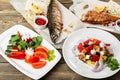 grilled mackerel and a salad of fresh vegetables. Serving on a wooden Board on a rustic table. Barbecue restaurant menu Royalty Free Stock Photo
