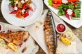 grilled mackerel and a salad of fresh vegetables. Serving on a wooden Board on a rustic table. Barbecue restaurant menu Royalty Free Stock Photo