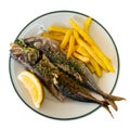 Grilled mackerels with French fries, lemon and sauce Royalty Free Stock Photo