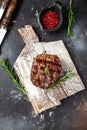 grilled meat barbecue steak on a wooden board. vertical image. top view. place for text Royalty Free Stock Photo