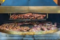 Grilled meat. Close-up cooking of large juicy pieces of raw, fat, natural, marinated pork meat, beef calves, rams on a griddle Royalty Free Stock Photo