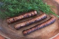 Grilled meat coops are served on a wooden plate with juicy dill greens Royalty Free Stock Photo