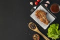 grilled meat copy space, dark surface, herbs, lettuce, tomato , black spice in the wooden spoons Royalty Free Stock Photo