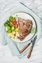 Grilled meat dinner plate with cooked beef tbone steak