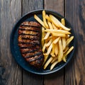 Grilled meat and fries presented enticingly on a wooden table