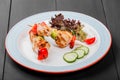 Grilled meat kebabs on skewers with vegetables, cherry tomato, pepper, zucchini in plate on dark wooden background. Royalty Free Stock Photo