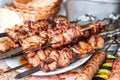 Grilled meat kebabs on the white plate. Skewered on wooden sticks tasty pork meat. Shashlik or Shish kebab. Royalty Free Stock Photo