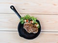 Grilled meat with marinated vegetables in a pan