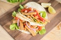 Grilled meat with onion and bell peppers, tomato,lettuce and serve with flour tortilla on wooden board. Royalty Free Stock Photo