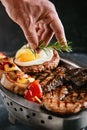 Grilled meat platter. Assorted delicious grilled meat with vegetables. Grilled mixed meat with pepper sauce and Royalty Free Stock Photo