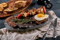 Grilled meat platter. Assorted delicious grilled meat with vegetables. Grilled mixed meat with pepper sauce and Royalty Free Stock Photo
