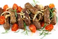 Grilled meat rolls with tomato and rosemary, close up Royalty Free Stock Photo