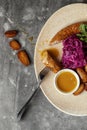 Grilled meat sausages and baked potatoes with vegetables on grey clay background. Royalty Free Stock Photo