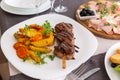 Grilled meat on a skewer with a side dish of vegetables and French fries Royalty Free Stock Photo