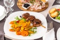 Grilled meat on a skewer with a side dish of vegetables and French fries Royalty Free Stock Photo