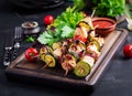 Grilled meat skewers, chicken shish kebab with zucchini, tomatoes and red onions Royalty Free Stock Photo