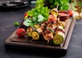 Grilled meat skewers, chicken shish kebab with zucchini, tomatoes and red onions. Royalty Free Stock Photo