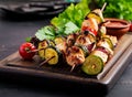 Grilled meat skewers, chicken shish kebab with zucchini, tomatoes and red onions. Royalty Free Stock Photo