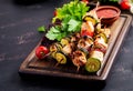 Grilled meat skewers, chicken shish kebab with zucchini, tomatoes and red onions. Royalty Free Stock Photo