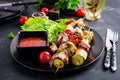 Grilled meat skewers, chicken shish kebab with zucchini, tomatoes and red onions Royalty Free Stock Photo