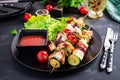 Grilled meat skewers, chicken shish kebab with zucchini, tomatoes and red onions. Royalty Free Stock Photo