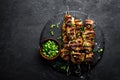 Grilled meat skewers, shish kebab on black background, top view Royalty Free Stock Photo