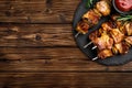 Grilled meat skewers, shish kebab on wooden background Royalty Free Stock Photo