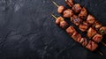 Grilled meat skewers with spices and cherry tomatoes on a dark slate background