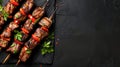 Grilled meat skewers with spices and cherry tomatoes on a dark slate background